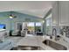 Open concept living area with view from kitchen, featuring beachy decor and access to the porch at 7442 Palm Island Dr # 3624, Placida, FL 33946