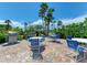 Outdoor community kitchen with BBQ grills, seating areas, and lush landscaping, perfect for entertaining at 7442 Palm Island Dr # 3624, Placida, FL 33946