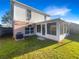 A well-maintained backyard, including a screened in patio, and grassy yard at 30208 Rattana Ct, Wesley Chapel, FL 33545