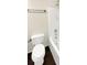 Bathroom with a toilet and a shower tub with dark wood-colored floors at 30208 Rattana Ct, Wesley Chapel, FL 33545