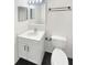 Cozy bathroom featuring a sink, toilet, mirror, and dark wood-colored floors at 30208 Rattana Ct, Wesley Chapel, FL 33545