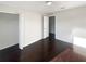 A simple bedroom with wood floors, white walls, and a closet at 30208 Rattana Ct, Wesley Chapel, FL 33545
