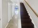 Hallway with stairs leading to the second floor and doors leading to other rooms at 30208 Rattana Ct, Wesley Chapel, FL 33545