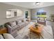 Comfortable living room with an arched window, plush sofa, and decorative rug at 30208 Rattana Ct, Wesley Chapel, FL 33545