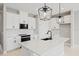 Modern kitchen with white cabinets and a large island at 522 Sun Chaser Dr, Nokomis, FL 34275