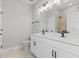 Modern bathroom with double vanity, updated fixtures and gray tile shower at 522 Sun Chaser Dr, Nokomis, FL 34275