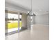 Dining room with sliding glass doors and lake view at 522 Sun Chaser Dr, Nokomis, FL 34275