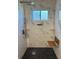 Large walk-in shower with marble tile and built-in seat at 2386 Sumatran Way # 26, Clearwater, FL 33763