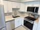 Renovated kitchen with stainless steel appliances and white cabinets at 2386 Sumatran Way # 26, Clearwater, FL 33763
