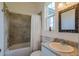 Clean bathroom with a shower/tub combo and granite vanity at 37600 Largo Ln, Dade City, FL 33523