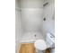 Updated bathroom with white tile shower and toilet at 4102 Dalwood Dr, Holiday, FL 34691