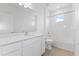 Modern bathroom featuring white cabinets, a large mirror, and a shower-tub combo, all in a clean, bright space at 9589 Vibrant Lane, Venice, FL 34292