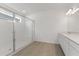 Modern bathroom with a glass-enclosed shower, dual vanity, and tile flooring at 9589 Vibrant Lane, Venice, FL 34292