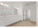 Modern bathroom featuring dual sinks, a large mirror, and a glass-enclosed shower at 9589 Vibrant Lane, Venice, FL 34292