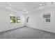 Bright bedroom with large windows, recessed lighting, and plush carpeting at 9589 Vibrant Lane, Venice, FL 34292