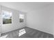 Bedroom boasts neutral carpet and walls, with two windows offering serene neighborhood views and natural light at 9589 Vibrant Lane, Venice, FL 34292