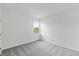 Simple bedroom features neutral carpet and walls with a window view at 9589 Vibrant Lane, Venice, FL 34292