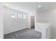 Bright bedroom features neutral walls and carpet, with natural light streaming in from the windows at 9589 Vibrant Lane, Venice, FL 34292