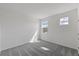Comfortable bedroom showcasing neutral carpet and walls, brightened by natural light from large, picturesque windows at 9589 Vibrant Lane, Venice, FL 34292