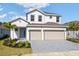 Charming two-story home with a three car garage and well-manicured landscaping at 9589 Vibrant Lane, Venice, FL 34292
