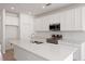 Bright kitchen featuring stainless steel appliances and a spacious island with a sink at 9589 Vibrant Lane, Venice, FL 34292