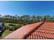 Image shows a red tile roof with a view of green space and blue sky in the background at 1304 Islamorada Blvd, Punta Gorda, FL 33955