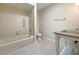 Neutral bathroom features a shower-tub combo, white toilet, and sink with chrome hardware at 7483 Carnoustie Dr # 5B, Sarasota, FL 34238