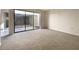 Bedroom with carpet, natural light, and large sliding glass door with access to the outside at 7483 Carnoustie Dr # 5B, Sarasota, FL 34238