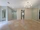 Dining room with tile flooring, chandelier, and large mirrors at 7483 Carnoustie Dr # 5B, Sarasota, FL 34238