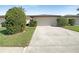 Charming home featuring a two-car garage, well-maintained landscaping, and a concrete driveway at 7483 Carnoustie Dr # 5B, Sarasota, FL 34238
