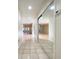 Hallway with tile floors and a mirrored closet at 7483 Carnoustie Dr # 5B, Sarasota, FL 34238