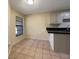 A bright kitchen eating space features a breakfast bar, tile floor, and a window at 7483 Carnoustie Dr # 5B, Sarasota, FL 34238