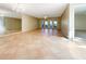 Spacious living room with tile flooring, large mirrors, and access to the patio at 7483 Carnoustie Dr # 5B, Sarasota, FL 34238