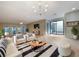 Bright living room with tile floors, modern lighting, stylish furniture, and access to a private outdoor space at 7483 Carnoustie Dr # 5B, Sarasota, FL 34238