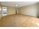 Bright bedroom with a ceiling fan, carpet flooring, neutral walls, and en-suite bathroom access at 7483 Carnoustie Dr # 5B, Sarasota, FL 34238