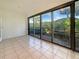 Enclosed patio with tile flooring and large sliding windows at 7483 Carnoustie Dr # 5B, Sarasota, FL 34238