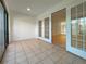 Enclosed tiled patio with glass doors and window for natural light at 7483 Carnoustie Dr # 5B, Sarasota, FL 34238
