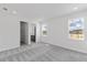 Bright bedroom with plush carpeting and large windows, leading to an ensuite bathroom at 9593 Vibrant Lane, Venice, FL 34292