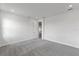 Neutral bedroom with plush carpeting and a doorway into an ensuite bathroom at 9593 Vibrant Lane, Venice, FL 34292