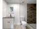 This bathroom boasts a modern vanity, toilet, and walk-in shower with accent tile at 4011 Mesa Ave, Sarasota, FL 34233