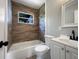 The updated bathroom has a modern vanity, toilet and tiled tub at 4011 Mesa Ave, Sarasota, FL 34233