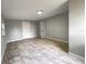 Spacious and bright bedroom with white marble floors and an entrance to the bathroom at 4011 Mesa Ave, Sarasota, FL 34233