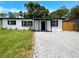 Charming single-story home with black trim, modern landscaping and a well-maintained lawn at 4011 Mesa Ave, Sarasota, FL 34233