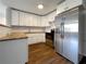 Kitchen featuring stainless steel appliances, white cabinets, subway tile backsplash and laminate counter tops at 4011 Mesa Ave, Sarasota, FL 34233