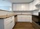 Kitchen featuring stainless steel appliances, white cabinets, granite counters and dark cabinet hardware at 4011 Mesa Ave, Sarasota, FL 34233
