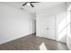 Light and airy bedroom features wood-look tile, a ceiling fan and closet at 24166 Colima Ct, Punta Gorda, FL 33955