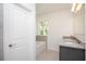 Bathroom featuring granite countertop double vanity and tiled tub surround at 5637 Ocarina Rd, North Port, FL 34291