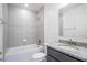 Bathroom featuring a shower-over-tub, granite countertop vanity, and tiled walls at 5637 Ocarina Rd, North Port, FL 34291