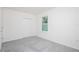 A bright bedroom showcasing neutral carpeting, a closet, and a window to let in natural light at 5637 Ocarina Rd, North Port, FL 34291