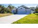 Charming single-story home with a three-car garage and long driveway at 5637 Ocarina Rd, North Port, FL 34291